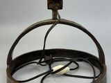 an old metal object with a wire and a light on it