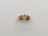 a close up of a gold ring on a white surface