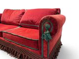 an image of a red couch with fringes on it