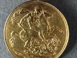 a gold coin with a gold flower on top of it