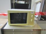 a microwave sitting on top of a desk in a room