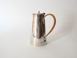 an image of a silver coffee pot on a white surface