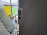 a toilet paper dispenser in the corner of a room