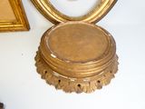 a clock that is sitting on a table next to a mirror