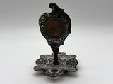 an image of a small metal object with a bird on top of it