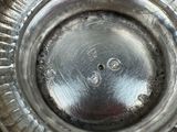 a close up of a silver plate with a hole in the middle