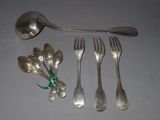 a spoon, fork, spoon and spoon rest next to each other
