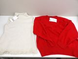 two sweaters that are sitting on a table
