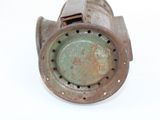 an old rusted metal object on a white surface