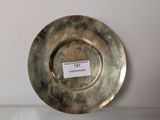 a silver plate sitting on a table with a label on it