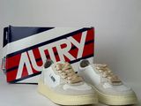 an image of a pair of white shoes with a box in the background