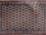 an oriental rug with a floral design on a beige background