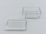 two clear glass square dishes on a white surface