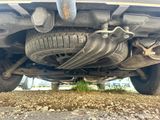 a close up of a car ' s exhaust pipe and exhaust muffler