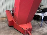 an image of a large red machine in a garage