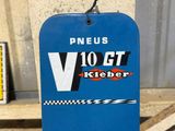 a blue sign hanging on the side of a building