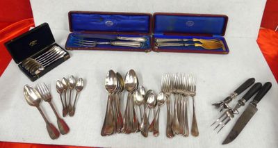a lot of silverware on a table with a red cloth