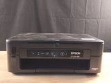 an image of a printer sitting on a wooden table