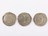 three silver coins, one of which is a roman coin and the other of which is a roman coin