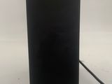 a black electronic device with a green light on it