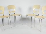 four yellow chairs sitting next to each other on a white surface