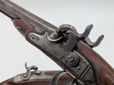 a close up of a gun on a white surface with a white background