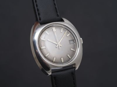 a close up of a watch with roman numerals on the face