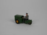 a green toy tractor with a man driving it