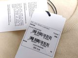 the label on a sweater is attached to a tag