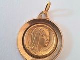 a close up of a gold coin with a woman ' s face on it