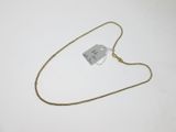 a close up of a gold chain with a tag on it