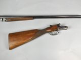an old gun and a shotgun on a white surface