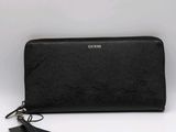 a black long wallet with a tag on the side of it