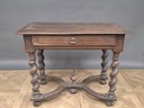 an old wooden table with a drawer on top of it on a hard wood floor