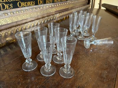 de nombreux verres posés sur une table à côté d'un panneau