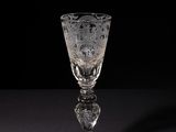 crystal wine glass on a black table with a black background