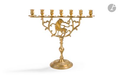 an image of a golden menorah with a monkey on top of it