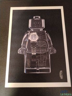 framed black and white photograph of a lego man with a clock on his face