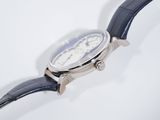 a close up of a watch on a white surface