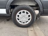 a close up of a tire on a truck in a parking lot