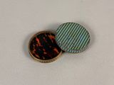 two buttons that are sitting on top of a table