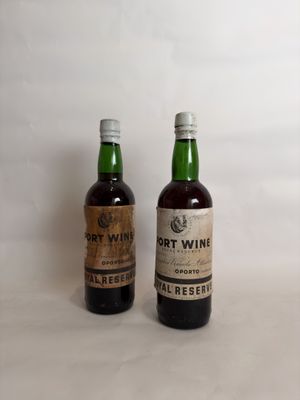 two bottles of port wine sitting next to each other on a table