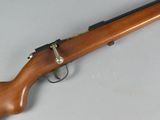 an old rifle with a wooden handle on a white surface