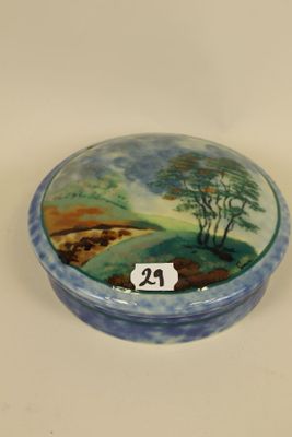 a small blue and white box with a painting on it