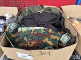 a cardboard box filled with clothes and other items
