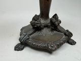 a vase that is sitting on a stand on a table