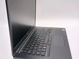 a laptop computer sitting on a table with a keyboard