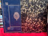 two books on a table with a red table cloth and a red table cloth