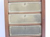 a tall wooden cabinet with five drawers on top of it