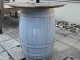 a wooden table with an umbrella on top of it